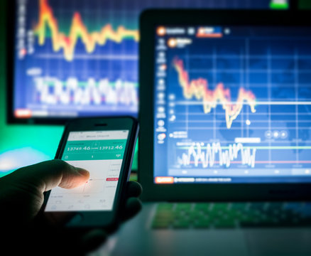 Crypto Currencies, trader using mobile phone and computers, Vienna Austria, 17.01.2018