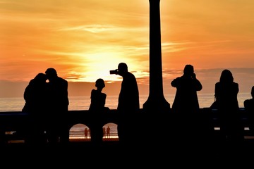 Fototapeta na wymiar Silhouettes watching sunset- Seaside, Oregon 4
