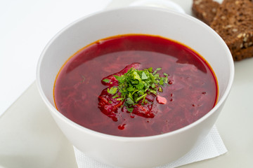 Classic russian beetroot soup: borscht with vegetables, garlic toasts and fresh sour cream