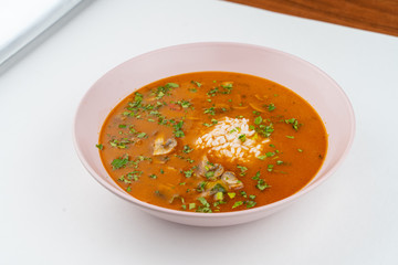 Spicy tomato soup with rice, bell pepper and champignon mushrooms isolated on white flat lay