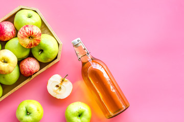 Vinegar made from fresh apple on pink background top view copy space