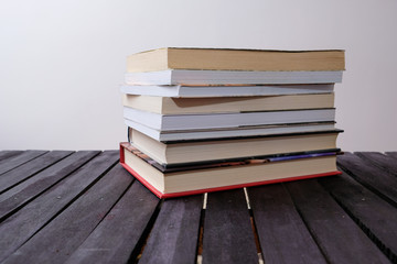 stack of books on wooden table closeup