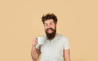 Awaking. Bearded man with cup of coffee. Tired guy hold coffee. Man hold cup with coffee. Coffee....