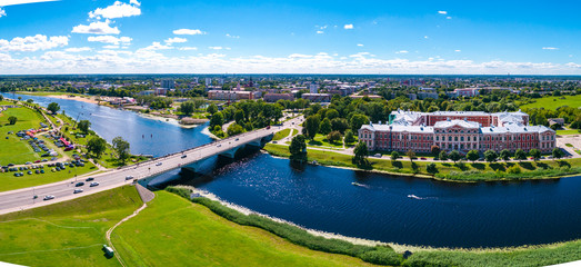 Panoramic view over city Jelgava, Lielupe river and ''Latvia University of Agriculture'' during sunny summer day. - obrazy, fototapety, plakaty