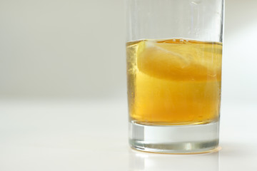 Scotch in a glass on a white table top and background
