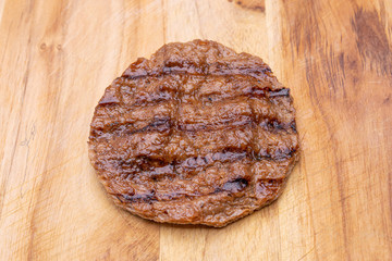 Vegan patty isolated on wooden background