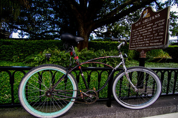 Fototapeta na wymiar Bike parked by New Orleans historical sign