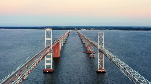 Aerial drone footage of Cheasapeake Bay Bridge, with camera pull back between the two bridge spans.