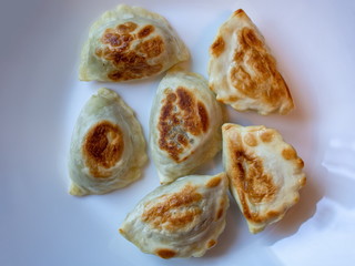 baked warm pierogies on the white plate ready to eat