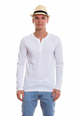 Studio shot of young handsome man standing