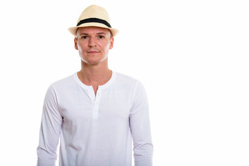 Studio shot of young handsome man wearing hat