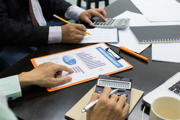 Business man Writing expense information in home office.team work concept