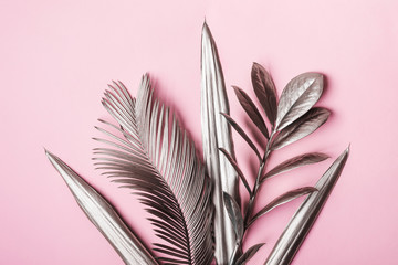 Natural Creative layout made of tropical leaves in silver metallic colors. Minimal surrealism background