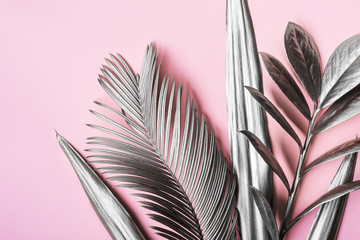 Painted in silver tropical leaves on pink pastel background. Natural Creative layout. Minimal surrealism background