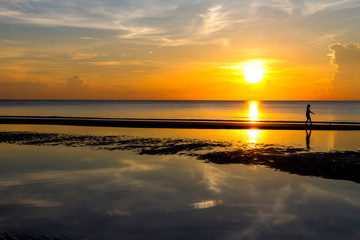 Sunrise with travealer walking at beach Ban Krut