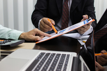 Business man Writing expense information in home office.team work concept