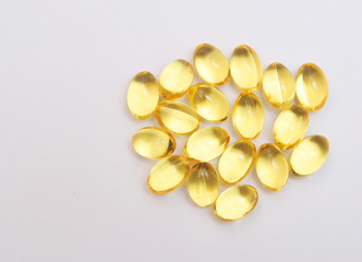 Fish fat in capsule on light background.