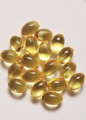 Fish fat in capsule on light background.