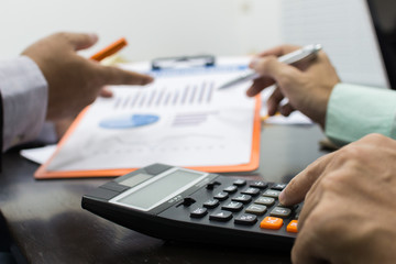 Business man Writing expense information in home office.team work concept