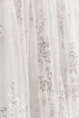 Details of the bride dress fabric and beautiful embroidery wedding concept used as a background for illustrations