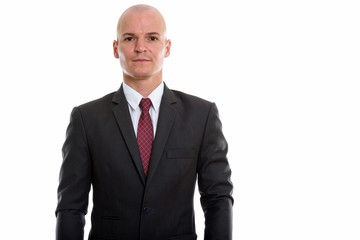 Studio shot of young handsome bald businessman