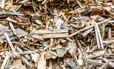 A pile of commercial wood waste is waiting to be chipped , ground and recycled. 