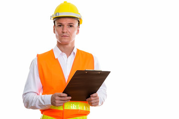 Studio shot of young handsome man construction worker holding cl