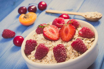 Vintage photo. Oat flakes and oatmeal with fruits, healthy lifestyle and nutrition concept