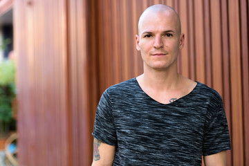 Obraz premium Portrait of young handsome bald man outdoors