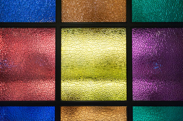 Decorative window of various colored rectangles with light coming through