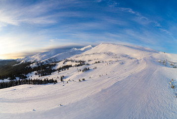 Naklejka na ściany i meble Picturesque winter panorama of mountain hills