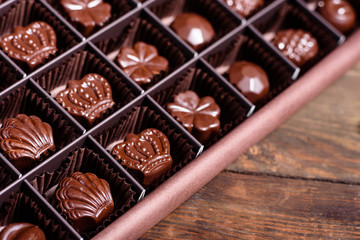 Assortment of fine chocolate candies, white, dark, and milk chocolate sweets background. Copy space. Top view. An assortment of fine chocolates in white, dark, and milk chocolate