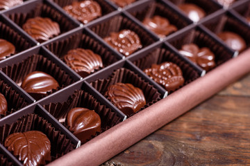 Assortment of fine chocolate candies, white, dark, and milk chocolate sweets background. Copy space. Top view. An assortment of fine chocolates in white, dark, and milk chocolate