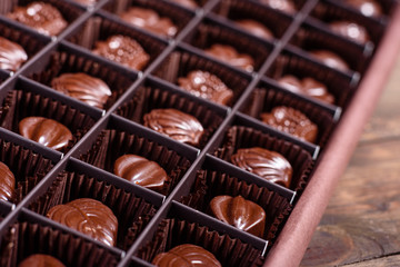 Assortment of fine chocolate candies, white, dark, and milk chocolate sweets background. Copy space. Top view. An assortment of fine chocolates in white, dark, and milk chocolate