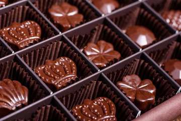 Assortment of fine chocolate candies, white, dark, and milk chocolate sweets background. Copy space. Top view. An assortment of fine chocolates in white, dark, and milk chocolate