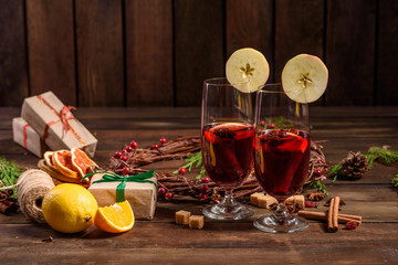 Christmas hot mulled wine with cinnamon cardamom and anise on wooden background