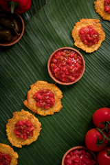 Banana Fritters with Tomato Chutney on top (also known as Patacones in Spanish, famous in Colombia) Post-Production: Rustic feel