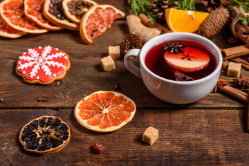 Christmas hot mulled wine with cinnamon cardamom and anise on wooden background