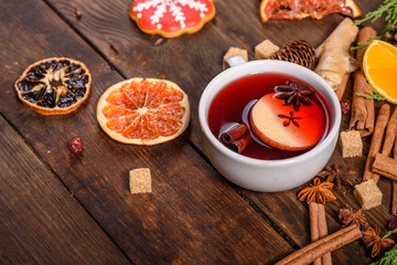 Christmas hot mulled wine with cinnamon cardamom and anise on wooden background