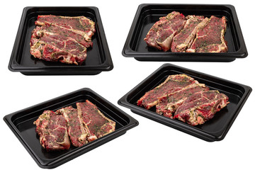Pieces of marinated meat in a black plastic container Ready for sale. White isolated.