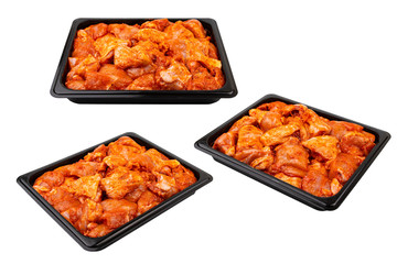 Marinated chicken in a black plastic container Ready for sale. White isolated.