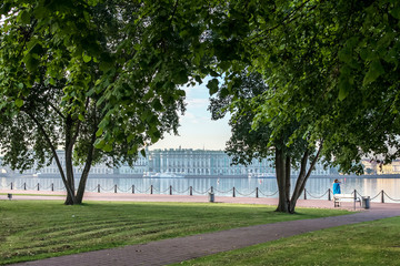 a green lawn and large trees offer a panoramic view of the Hermitage