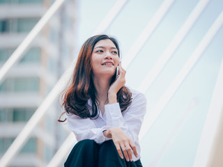 Asian young business woman with mobile phone