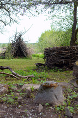 hut and nest of old dry branches as art objects in the garden-an example of the use of garden moussor in landscape design