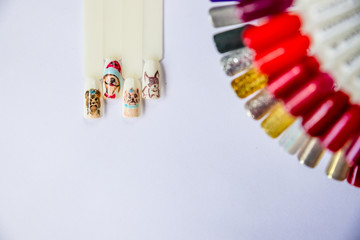 Christmas Nail art manicure. Winter Holiday style bright Manicure with gems Christmas tree and snowflakes. Bottle of Nail Polish. Beauty hands. Trendy Stylish Colorful Nails, Nailpolish