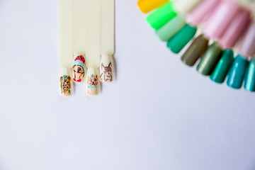 Christmas Nail art manicure. Winter Holiday style bright Manicure with gems Christmas tree and snowflakes. Bottle of Nail Polish. Beauty hands. Trendy Stylish Colorful Nails, Nailpolish