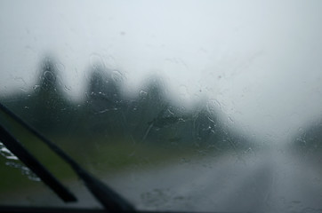 wet windshield of the car, which in a heavy downpour rides on the road with poor visibility. caution, emergency situation