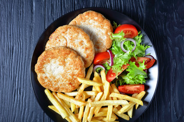 turkey burgers served with salad and fries