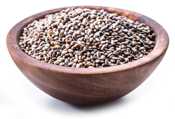 Chia seeds in wooden bowl isolated on white background.