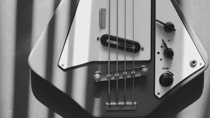 rare bass guitar closeup in the sun light . black and white